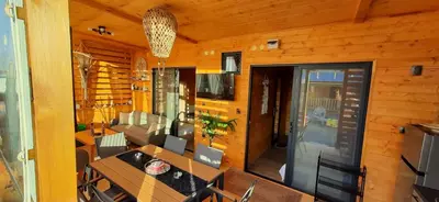 a room with a table and chairs in a cabin at Бунгало Шангри Ла - 1, плаж Градина in Sozopol