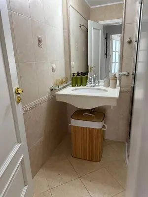 a bathroom with a sink and a mirror at Flores Garden Pool Side and Sea View Apartment in Chernomorets