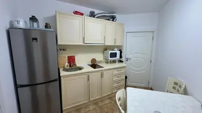 a kitchen with a refrigerator and a sink at Слънчево Море in Nesebar