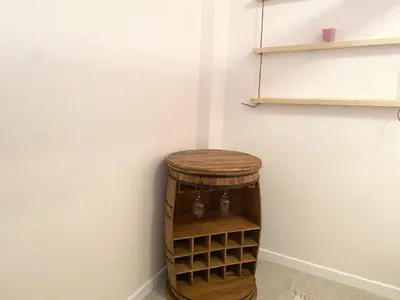 a wooden stool in a corner of a room at New Yorker 2 bedroom apartment in Varna City