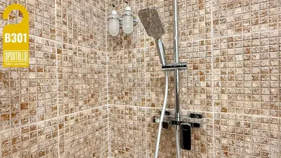 a shower in a bathroom with a brick wall at ROYAL BEACH - Private Apartments - Center of Sunny Beach in Sunny Beach