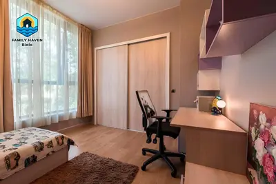 a bedroom with a desk and a bed and a desk at Вилла Biala family haven in Byala