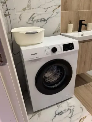 a washing machine in a bathroom next to a sink at Central Park 7 in Burgas City