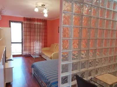 a living room with a wall of glass at Vigo apartment in Nesebar