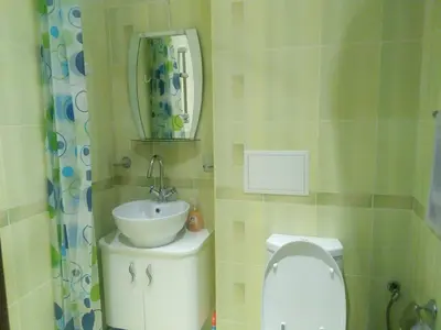a bathroom with a sink and a toilet and a mirror at Vigo apartment in Nesebar