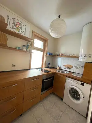 a kitchen with a sink and a washing machine at Bonne Chance Apartment Sozopol in Sozopol