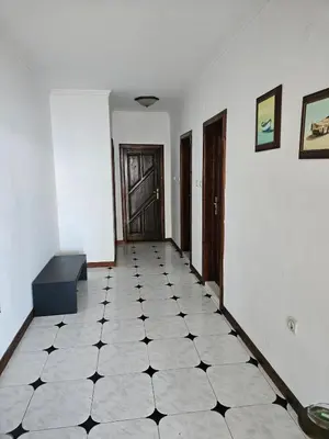 a hallway with a black and white tiled floor at Lazur Family Apartment Pomorie in Pomorie