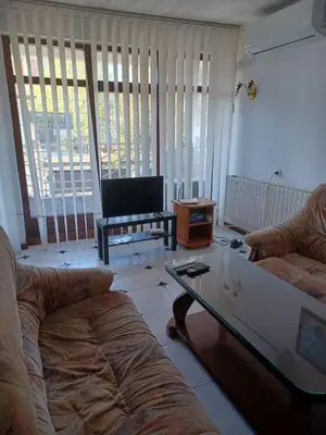 a living room with two couches and a coffee table at Lazur Family Apartment Pomorie in Pomorie