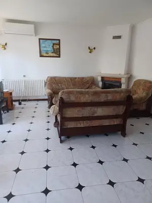a living room with a couch and a tiled floor at Lazur Family Apartment Pomorie in Pomorie