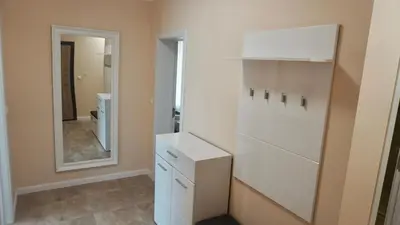 a bathroom with a white cabinet and a mirror at Апартаменти Bella Deluxe in Ravda