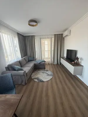 a living room with a couch and a tv at Meerblick , Etera 4 in Sunny Beach