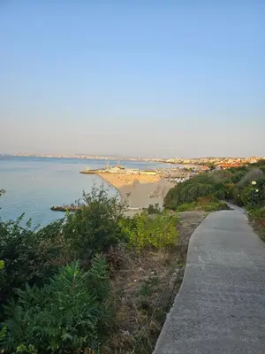 a path next to a beach with a body of water at Meerblick , Etera 4 in Sunny Beach