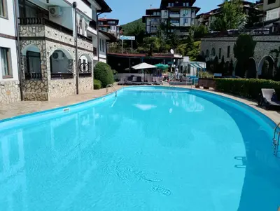 a large blue swimming pool next to a building at ETARA - 1 Rey&Mar Saint Vlas in Sveti Vlas