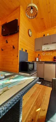a kitchen with wooden walls and a wooden floor at Бунгало Шангри Ла - 2, плаж Градина in Sozopol