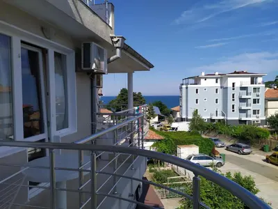 a balcony with a view of a building at Guest house Pepina in Obzor