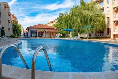 a large blue swimming pool in a building at Double Cream Apartment in Tŭnkovo