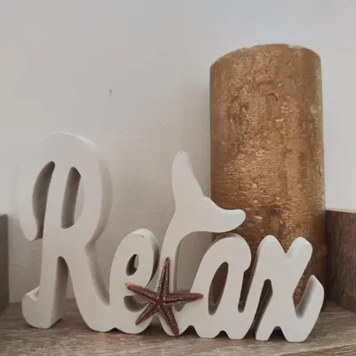 a wooden sign that says raw next to a starfish at Apartment Violeta - with sea view in 1st line Sarafowo in Burgas City
