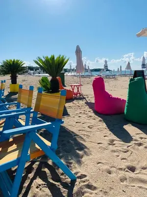 a group of chairs sitting on a beach at Apartment Violeta - with sea view in 1st line Sarafowo in Burgas City