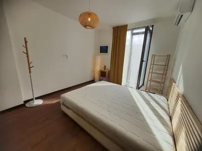 a bedroom with a bed and a large window at Вила Винсент - Villa Vincent in Lozenets