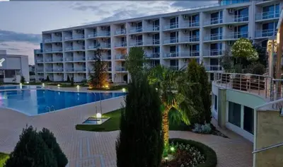 a large apartment building with a large swimming pool at The Red Studio in Burgas City