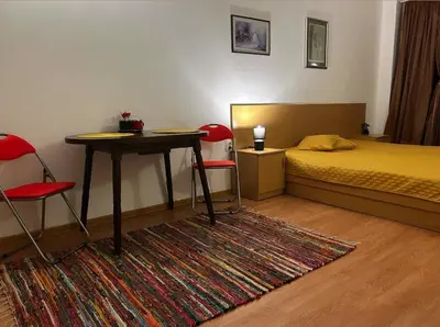 a bedroom with a bed and a table and chairs at The Red Studio in Burgas City
