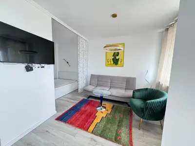 a living room with a couch and a chair at Luxus Art Apartament Burgas in Burgas City