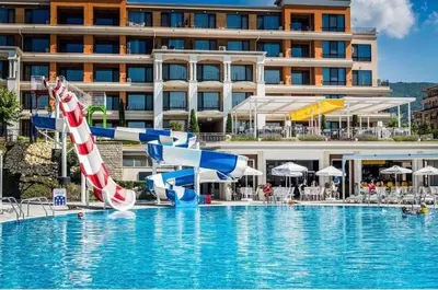 a resort pool with an inflatable pool slide at Premier Fort Beach Sveti Vlas in Sveti Vlas