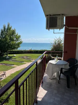 a balcony with a table and a view of the ocean at Fort Noks PRIVILEGE Apartment in Sveti Vlas