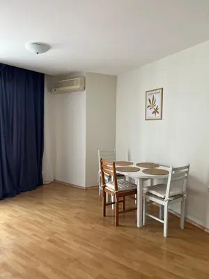 a dining room with a white table and chairs at Fort Noks PRIVILEGE Apartment in Sveti Vlas