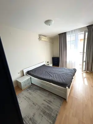 a bedroom with a bed in a room with a window at Fort Noks PRIVILEGE Apartment in Sveti Vlas
