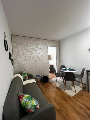 a living room with a couch and a table at Съни Дей ,Слънчев бряг in Burgas City