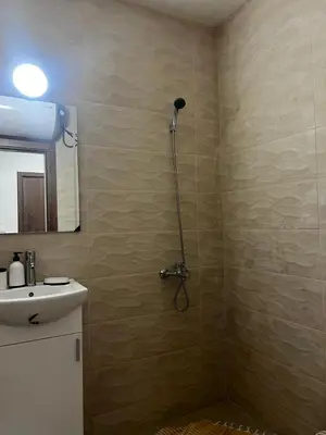 a bathroom with a shower and a sink at Съни Дей ,Слънчев бряг in Burgas City