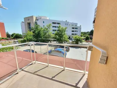 a balcony with a view of a building at Neptun-Yellow in Primorsko