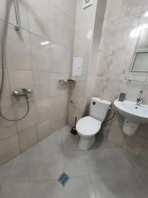 a bathroom with a toilet and a sink at Neptun-Yellow in Primorsko