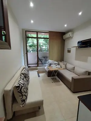 a living room with a couch and a table at Pacyfik3 in Sunny Beach
