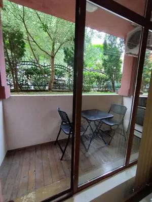 a balcony with two chairs and a table and a window at Pacyfik3 in Sunny Beach