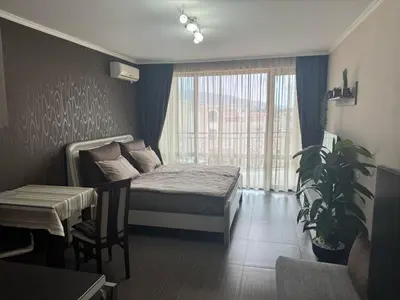 a bedroom with a bed and a large window at Lovely Studio with Sea View Grand Hotel Sveti Vlas in Sveti Vlas