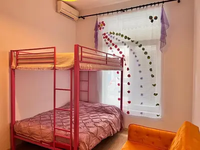 a bedroom with two bunk beds and a window at GALI- beach&mud therapy in Pomorie