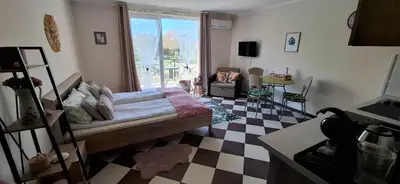 a bedroom with a bed and a checkered floor at Cozy Studio in Hacienda by Flat Mаnager in Sozopol