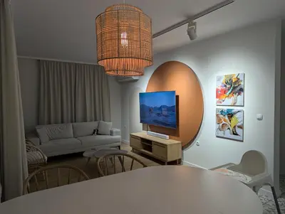 a living room with a tv and a couch at Solea Suites in Chernomorets
