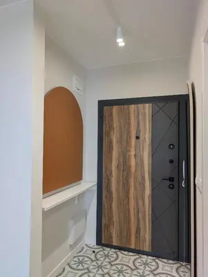 a bathroom with a shower with a wooden door at Solea Suites in Chernomorets