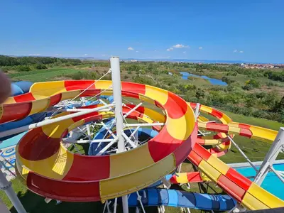 a group of colorful rides on a roller coaster at Rainbow 2 studio 7 in Sunny Beach