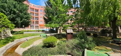 a garden in front of a large building at Rainbow 2 studio 7 in Sunny Beach