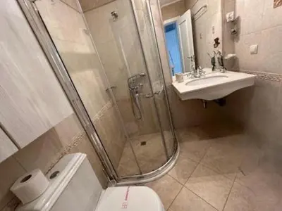 a bathroom with a shower and a toilet and a sink at Solea Studio in Chernomorets
