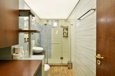 a bathroom with a shower with a toilet and a sink at Budget Flat in Central Varna in Varna City