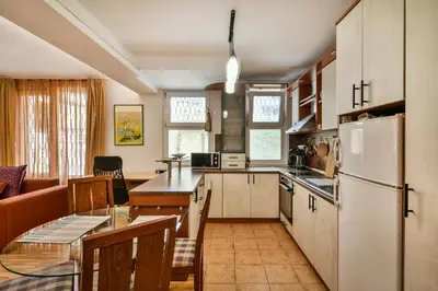 a kitchen with a white refrigerator and a table at Budget Flat in Central Varna in Varna City