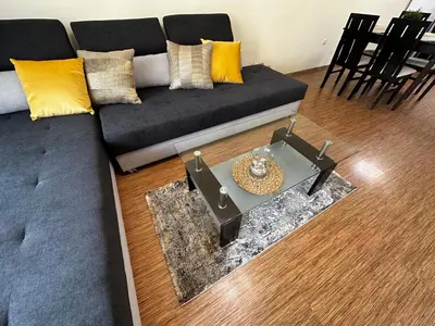 a living room with a couch and a table at Perfect Sea and Pool View Long Beach Apartment in Shkorpilovtsi