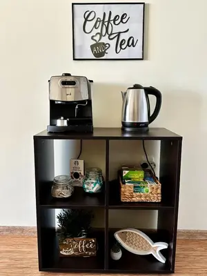 a black shelf with a coffee maker on top of it at Perfect Sea and Pool View Long Beach Apartment in Shkorpilovtsi