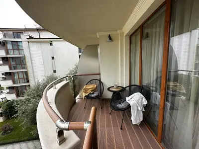 a balcony with a table and chairs on a balcony at Perfect Sea and Pool View Long Beach Apartment in Shkorpilovtsi