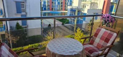 a table and chairs on a balcony with a view of buildings at Rainbow 2 studio 40 in Sunny Beach
